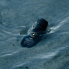Diffuser oil bottle lying on its side, dark ribbed cap visible