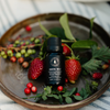 Black diffuser oil bottle with ribbed black cap and Wild Raspberry label text