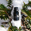 Cathedral Grove diffuser oil bottle on snow with green branches around