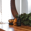Trails End room spray bottle with dark glass and black spray cap