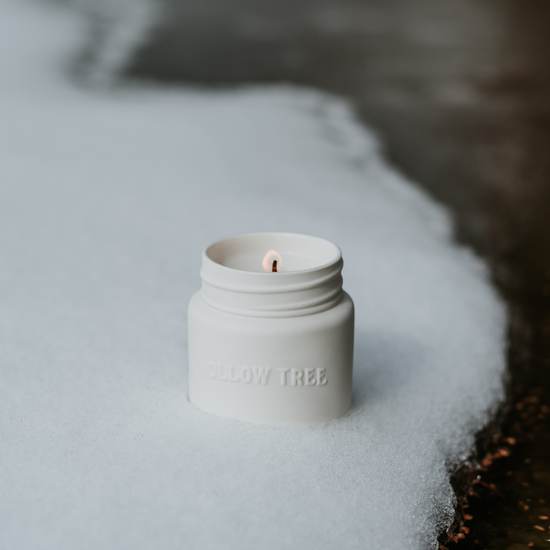 White candle jar with exposed wick