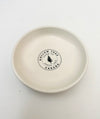 Ceramic candle catch dish with centered Hollow Tree Canada logo