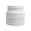 A white ceramic candle jar with the brand name 'HOLLOW TREE' embossed on the front.