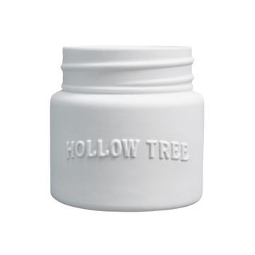 A white ceramic candle jar with the brand name 'HOLLOW TREE' embossed on the front.
